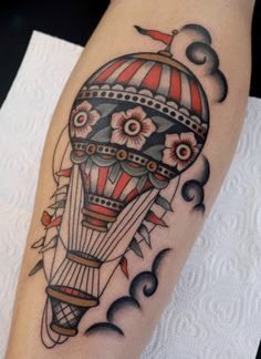 a hot air balloon tattoo design on the right arm and lower half of the leg