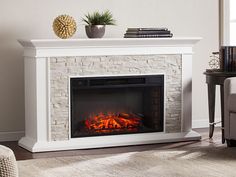 a living room with a fire place in the center and a painting on the wall