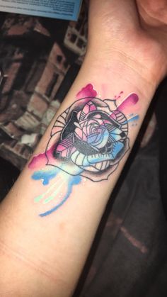 a woman's arm with a tattoo on it that has a rose in the center