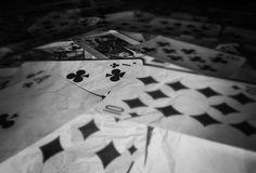 playing cards are scattered on the floor in this black and white photo