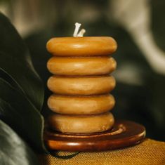 a stack of wooden candles sitting on top of a table