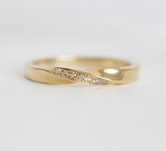 a yellow gold wedding band with white diamonds