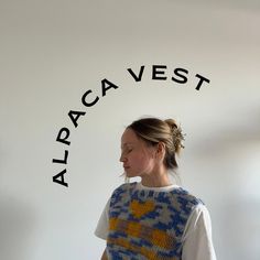 a woman standing in front of a sign that says alpaca west