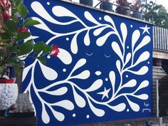 a blue and white painting on the side of a building