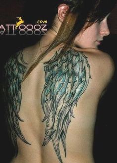 the back of a woman's body with tattoos on it