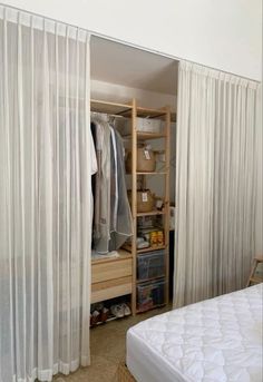 an open closet with clothes and other items in it