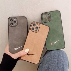 three iphone cases in different colors and sizes, one with a nike logo on the back