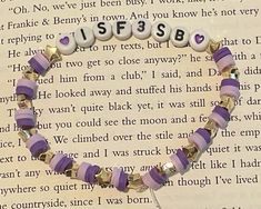 a purple and white beaded bracelet that says usf's b on it