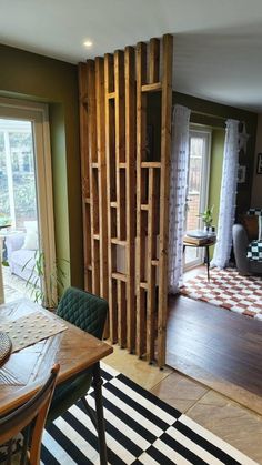 a living room with a table and chairs next to a sliding glass door