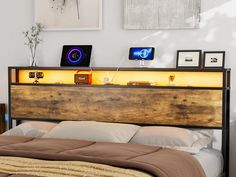 a bed with a wooden headboard and night lights on it's shelf above the bed