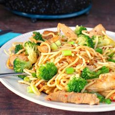 a white plate topped with noodles and broccoli