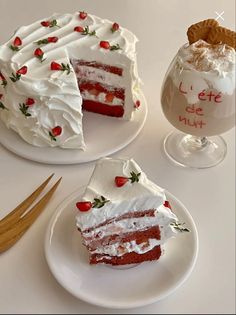 two slices of red velvet cake with white frosting and strawberries on the top