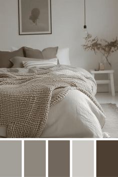 a bedroom with white walls and neutrals in the color scheme, along with gray bedding