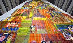 a very long table covered in colorful art