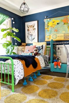 a bedroom with blue walls, yellow and white rugs and colorful decor on the floor