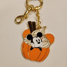 a mickey mouse keychain with an orange pumpkin