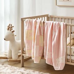 a baby crib with a rocking horse next to it