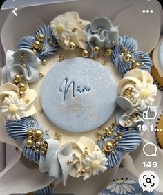 a close up of a cake in a box with flowers and decorations on it's side