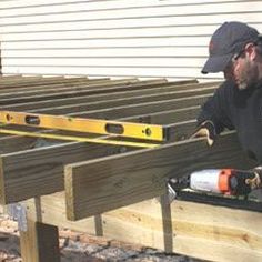 a man working on a wooden bench with tools