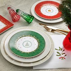 a table set for christmas with plates and napkins