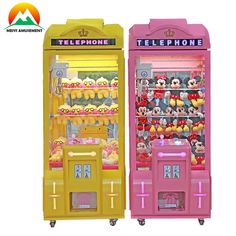 two toy vending machines with mickey mouses on them, one is pink and the other is yellow