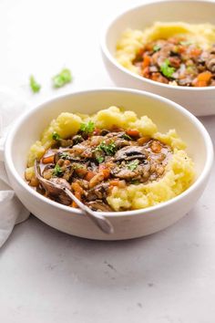 two white bowls filled with mashed potatoes and meat