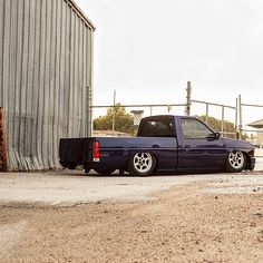 a blue truck parked in front of a building