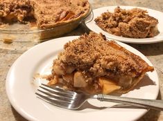 a slice of apple pie on a plate with a fork next to it and another half eaten pie in the background