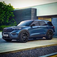 a blue suv parked in front of a building