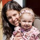 a woman holding a baby in her arms