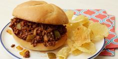 a sloppy joe sandwich on a plate with chips