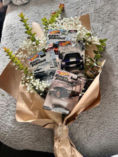 a bouquet of flowers sitting on top of a couch next to a book and magazine