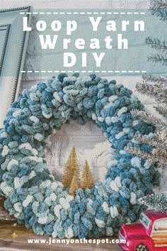 a blue and white wreath sitting on top of a table next to a red truck