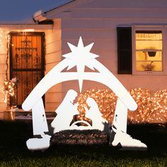 a christmas nativity scene in front of a house