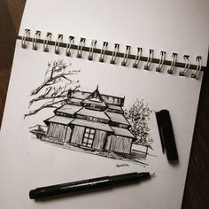 a drawing of a house with a pen next to it