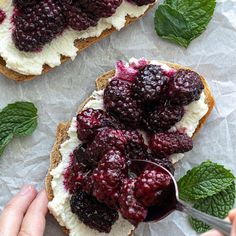 two pieces of bread with berries and cream on them