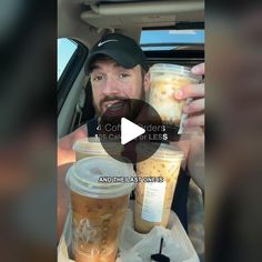 the man is holding two cups of iced coffee