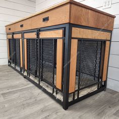 the dog kennel is made out of wood and black iron bars, which are attached to the wall