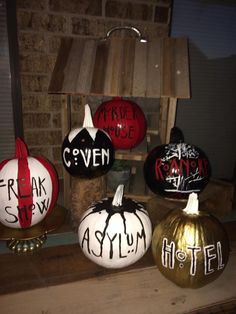 several painted pumpkins sitting on top of a table