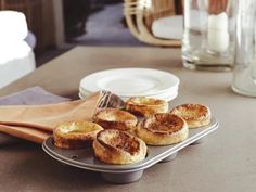 small pastries are on a plate next to some napkins