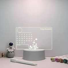 a desk with a calendar and markers on it