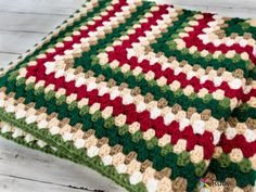 two crocheted pillows sitting on top of a white wooden floor next to each other