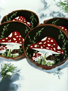 two wooden slices with mushrooms and leaves on them