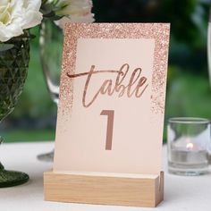 a table number is placed on a wooden stand