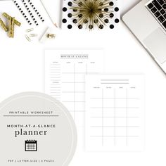 the printable planner is next to a laptop