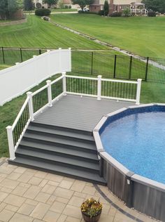 an above ground pool with steps leading up to it and a fenced in area