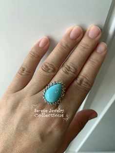 Pretty Levian Sleeping Beauty Turquoise diamond ring, This cabochon is cut in a cute teardrop shape and has a halo of round brilliant diamonds. Ring Size: 7 Total Weight: 8.31 grams Precious Metal: 14k yellow gold Precious stones: -Sleeping Beauty Turquoise Center Stone: 17mmx11.5mm, 13.8 carats -White Round Diamonds: 0.63 carats Hallmark: Levian, 14k Diamond Teardrop Jewelry With Accent Stones, Fine Jewelry Turquoise Ring With Diamond Accents, Elegant Turquoise Cabochon Diamond Ring, Teardrop Center Stone Jewelry, Elegant Turquoise Teardrop Ring For Anniversary, Turquoise Diamond Ring As Gift, Turquoise Diamond Ring With Diamond Accents As Gift, Turquoise Diamond Ring As A Gift, Gift Diamond Turquoise Cabochon Ring