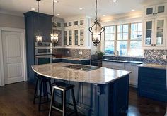 a large kitchen with an island in the middle