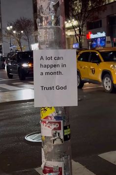 a sign on a pole that says, a lot can happen in a month trust god