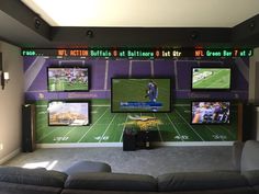 a sports themed living room with tvs and couches in front of the wall